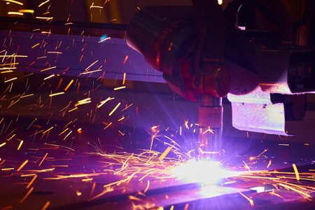 CNC Plasma Cutting Machine and Sparks in Metal Fabrication Shop