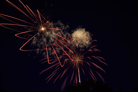 Red and Gold Fireworks Display at Night with Motion Blur Effect