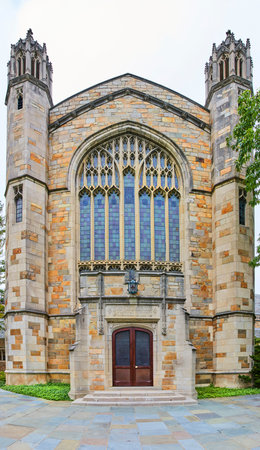 Majestic Gothic Revival Church Facade with Stained Glass, Overcast Sky