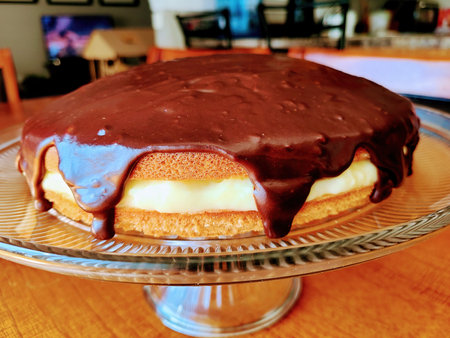 Homemade Boston Cream Pie Cake on Glass Pedestal, Cozy Indoor Setting