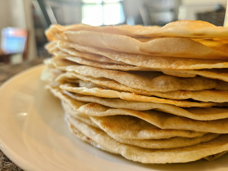 Golden Brown Tortilla Stack in Cozy Kitchen Settingの写真素材