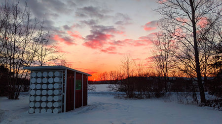 Winter Sunset at Eco-Friendly Composting Facility, Snow-Covered Landscapeの写真素材