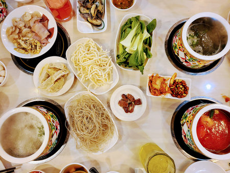 Communal Hot Pot Dining Experience with Fresh Ingredients, Overhead Viewの写真素材
