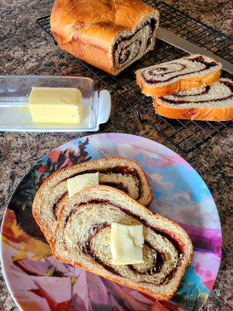 Homemade Cinnamon Raisin Bread with Butter on Plate, Eye-Level View