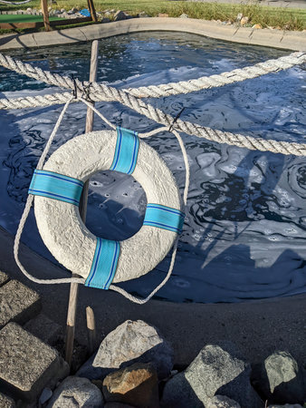 Lifebuoy by Sunny Outdoor Pool with Safety Ropesの写真素材