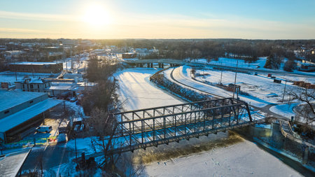 Aerial Winter Sunset on Wells Street Bridge, Snowy Riverbanks and Fort Wayneの写真素材
