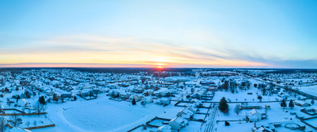 Aerial Winter Sunset Over Snowy Suburban Grid, Panoramaの写真素材