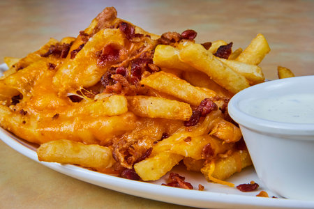 Fresh Cheesy Bacon Fries with Ranch Sauce on Table