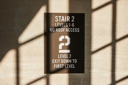 Directional Signage with Geometric Shadows on Concreteの写真素材