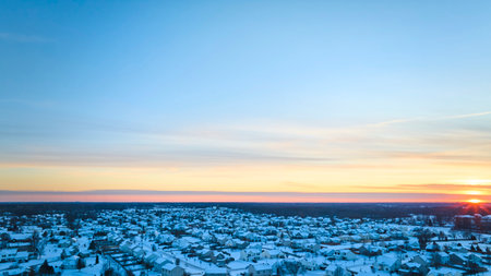 Aerial Sunrise over Snowy Suburban Neighborhood at Dawnの写真素材