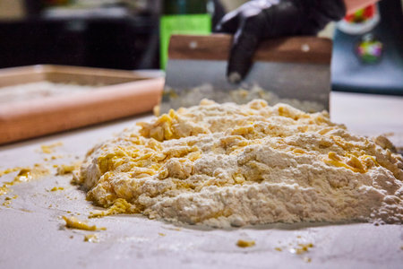 Artisan Dough Preparation, Gloved Hands with Scraper - Kitchen Close-Up