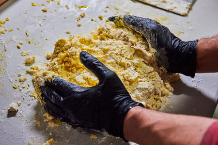 Artisan Kneading Dough with Black Gloves, Eye-Level Kitchen View