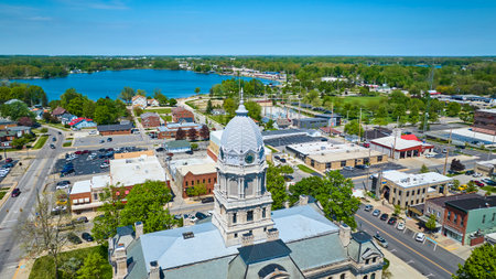 Aerial view of Warsaw, Indiana, showcasing the historic courthouse and vibrant community life by the...