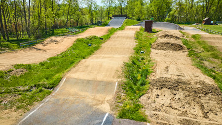 Aerial view of a serene BMX track in Warsaw, Indiana, nestled among lush greenery on a sunny day.の写真素材