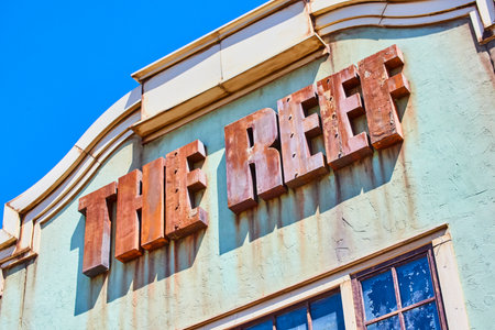 Vintage THE REEF Sign on Weathered Building Facade, Urban Indianaの写真素材