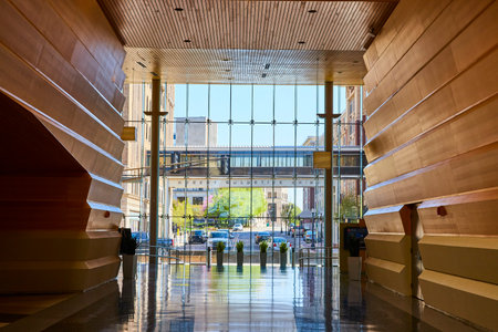 Modern Lobby with Wood Panels, Glass Facade, and Reflective Floor, Eye-Level View