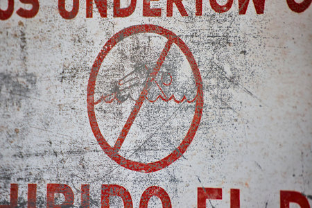 Weathered No Swimming Sign, Textured Close-Up Perspectiveの写真素材
