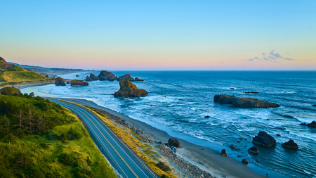 Aerial View of Scenic Coastal Road and Sea Stacks at Sunset in Oregonの写真素材