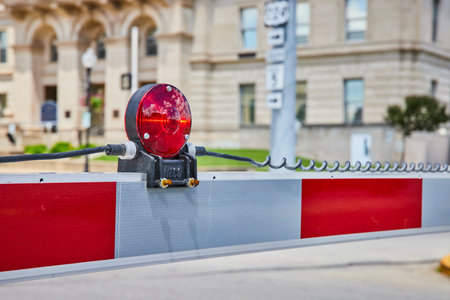Red Warning Light on Barrier Fronting Courthouse Urban Eye-Level View