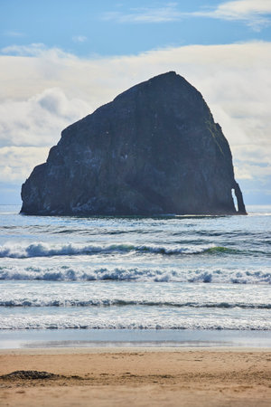Sea Stack and Rolling Waves Along Oregon Coastline Eye-Level Perspectiveの写真素材