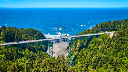 Aerial View of Thomas Creek Bridge Over Forested Gorge and Oceanの写真素材