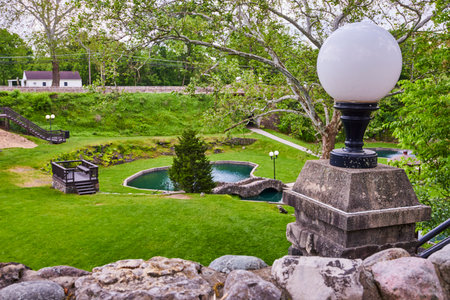 Lush Sunken Gardens with Stone Bridge and Lamp Viewed from Aboveの写真素材