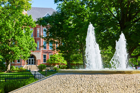 Twin Water Fountains and Red Brick Building on Suny Campus Day