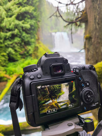 Waterfall and Forest Through DSLR Screen on Tripodの写真素材