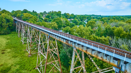 Aerial View of Rustic Railway Trestle Bridge Over Lush Valleyの写真素材