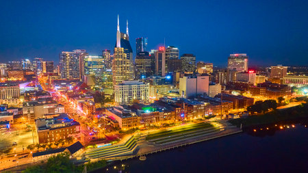 Aerial View of Nashville Nightlife and Skyline with Riverfront Reflectionsの写真素材