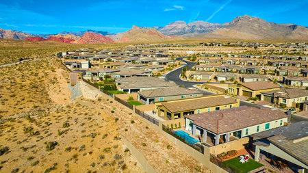 Aerial of Suburban Homes Against Red Rock Canyon Desert Backdropの写真素材