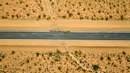 Aerial Desert Road and Sandy Landscape Top Down Viewの写真素材