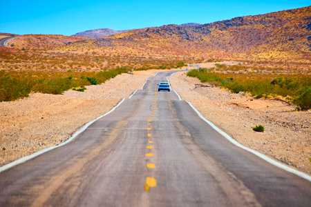Solitary Car on Desert Road in Moapa Valley Eye Level Perspective