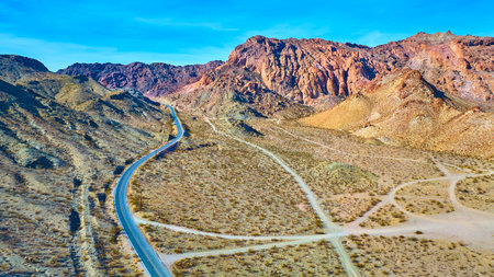 Aerial of Desert Road and Rocky Hills in Nevada