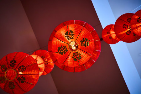 Vibrant Red Chinese Lanterns in Motion Viewed from Belowの写真素材