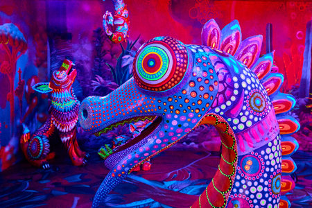 Vibrant Alebrije Dragon Art Installation in Neon Glow Eye-Level Viewの写真素材