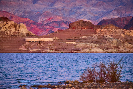 Golden Desert Lake and Abandoned Structure at Sunset Eye Levelの写真素材