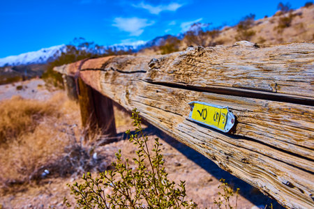Rustic Wooden Fence in Desert Landscape with Mountain Backdrop Low Angleの写真素材