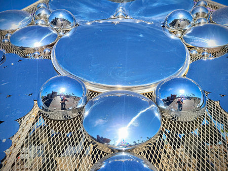 Reflective Metallic Spheres on Mesh Surface in Urban Sunlight at Eye Levelの写真素材