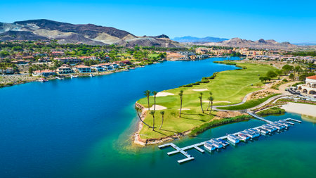 Aerial Luxury Waterfront Golf Course Community with Lake and Homes Fly Overの写真素材