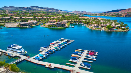 Aerial Marina and Luxury Waterfront Homes on Blue Lake with Boating Motionの写真素材