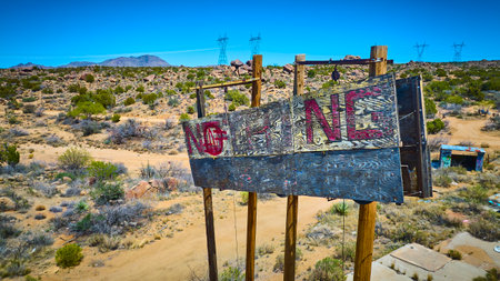 Aerial Abandoned Wooden Sign Desert Landscape Power Lines Elevated Viewの写真素材