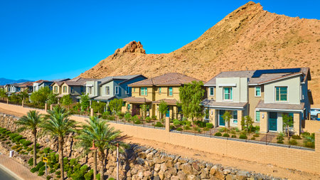 Aerial Modern Suburban Homes Desert Edge with Mountain View Fly Overの写真素材