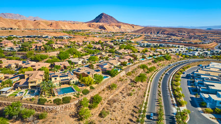 Aerial Suburban Neighborhood with Pools and Desert Mountains Fly Overの写真素材