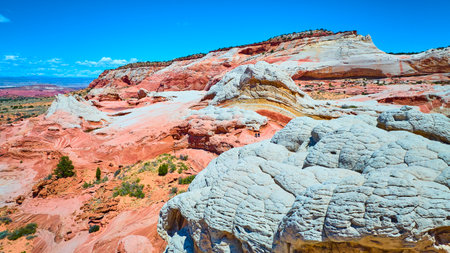 Aerial Through of White Pocket Sandstone Layers and Swirling Vermilion Cliffsの写真素材