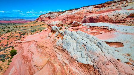 Aerial Fly Over Vibrant Red Rock Formations and Desert Plains White Pocketの写真素材