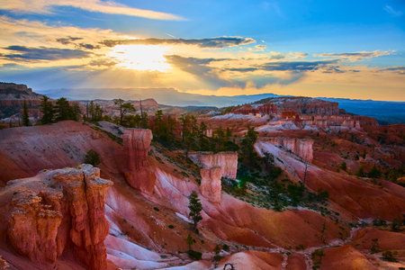 Bryce Canyon National Park Hoodoo Formations at Sunset with Pine Trees and Dramatic Skyの写真素材