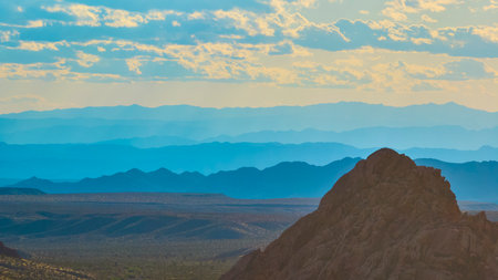 Aerial Layered Mountain Ranges and Rocky Outcrop with Dramatic Desert Skyの写真素材