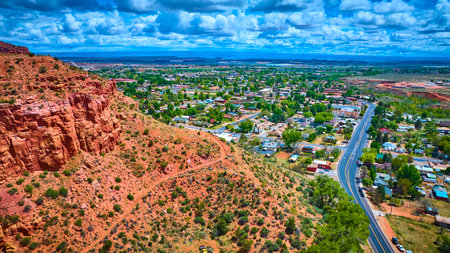 Aerial Red Rock Cliffs and Small Town Landscape in Southwest Utahの写真素材