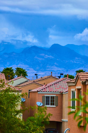 Suburban Desert Homes with Palm Trees and Stormy Mountains Nevadaの写真素材
